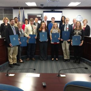 The Virginia Board of Education honored seven public school teachers in grades 7-12 who have been selected as state finalists for the 2017 Presidential Award for Excellence in Mathematics and Science Teaching. First row (l-r) Timothy Couillard (Chesterfield County), Blythe Samuels (Powhatan County), David Barnes (Maggie L. Walker Governor's School), Tara Brunyansky (Chesterfield County), Elisa Tedona (Chesterfield), William Daly (Albemarle County, Dianna McDowell (Virginia Beach); second row board members Kim Adkins, Jamelle Wilson, Anne Holton, Sal Romero, Supt of Public Instruction Steve Staples, Vice President Diane Atkinson, Tamara Wallace, Jim Dillard, Elizabeth Lodal.